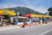 a row of shops on the side of a street at JMA FERRINGHI BEACH HOTEL in Batu Ferringhi
