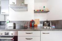 a kitchen with white cabinets and a sink at T3 La Tronche Near hospital #A5 in La Tronche