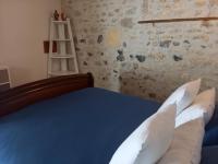 a bedroom with a blue bed and a ladder at La charentaise ch d&#39;hôtes ,Studio in Chérac
