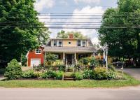 a house with flowers in the front yard at Farmhouse Inn B&amp;B in Canning