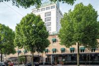 a tall white building with trees in front of it at Elite Park Avenue Hotel in Gothenburg
