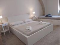 A bed or beds in a room at Affittacamere La Torre