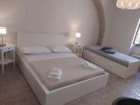 A bed or beds in a room at Affittacamere La Torre