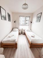 Posteľ alebo postele v izbe v ubytovaní Apartament Kraków Arena