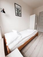Posteľ alebo postele v izbe v ubytovaní Apartament Kraków Arena