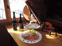 a table with a plate of food and two bottles of wine at La Bournerie in Le Grand-Bornand