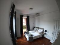 A bed or beds in a room at EMI's Guest House