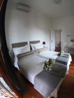 A bed or beds in a room at EMI's Guest House