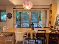 a dining room with a wooden table and chairs at Star Wish B&amp;B in Dongshan