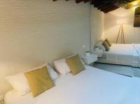 A bed or beds in a room at La Torre di Borgunto - Piazza Grande