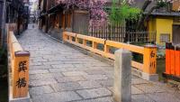 an alley with a wooden fence and a stone sidewalk at Kyoto Inn Gion The Second in Kyoto