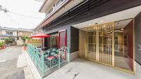 a restaurant with a table and chairs and an umbrella at Kyoto Inn Gion The Second in Kyoto