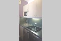 a kitchen with white cabinets and a stove top oven at 7 min Walk Metro Line 1-La Defense Charras in Courbevoie