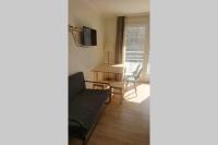 a living room with a couch and a table at 7 min Walk Metro Line 1-La Defense Charras in Courbevoie