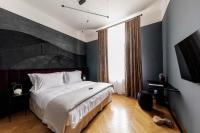 A bed or beds in a room at Zola Hotel - Palais de Bohème Adults Only