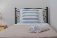 A bed or beds in a room at Tzortzi's Family Apartments