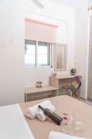 A bed or beds in a room at Tzortzi's Family Apartments