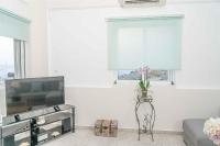 A television and/or entertainment centre at Tzortzi's Family Apartments