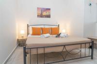 A bed or beds in a room at Tzortzi's Family Apartments