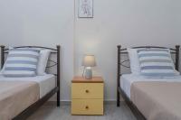 A bed or beds in a room at Tzortzi's Family Apartments