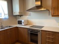 a kitchen with a microwave and a stove top oven at Casita Planes Surroca in Bourg-Madame