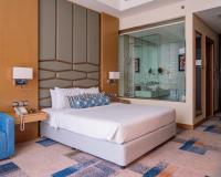 a bedroom with a large bed and a bathroom at Canal Central Hotel Business Bay in Dubai