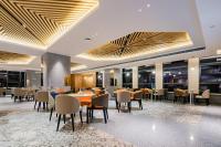 a dining room with tables and chairs and windows at Holiday Inn Express Xi'an High Tech Zone North by IHG in Xi'an