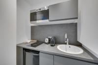 a kitchen with a sink and a microwave at Le Bellevue in Paris