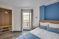a bedroom with a large bed and a balcony at Le Bellevue in Paris