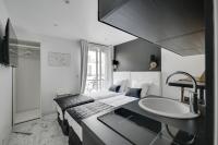 a hotel room with a sink and a bed at Le Bellevue in Paris