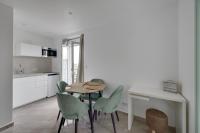 a kitchen and dining room with a table and chairs at Le Bellevue in Paris