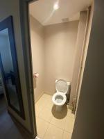 a bathroom with a white toilet in a room at Residence Chatillon in Paris