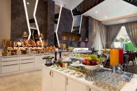 a breakfast buffet in a hotel room with food at Ramada by Wyndham Aligarh GT Road in Alīgarh