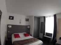 a bedroom with a bed with red pillows on it at Residence Chatillon in Paris