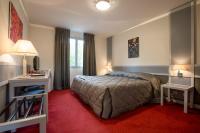 a bedroom with a bed and a red carpet at Hostellerie St Vincent in Nuits-Saint-Georges
