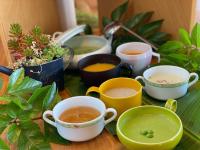 a table topped with cups of tea and plants at Ibusuki Royal Hotel in Ibusuki