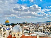 a view of the city of jerusalem with the dome of the rock at New Citadel Hostel in Jerusalem