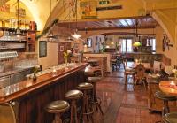 a bar with wooden stools in a restaurant at Hotel Mader in Steyr