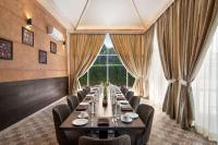 a long dining room with a long table and chairs at Ramada by Wyndham Aligarh GT Road in Alīgarh