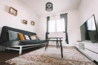 a living room with a couch and a tv at La Perlina - Appartement + Parking - V-rent in Annecy