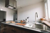 a kitchen with a sink and a counter top at La Perlina - Appartement + Parking - V-rent in Annecy