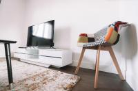 a living room with a tv and a chair at La Perlina - Appartement + Parking - V-rent in Annecy