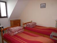 a bedroom with two beds and a window at les volets bleus in Camaret-sur-Mer