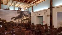 a room with chairs and a large painting on the wall at lodge 61 hotel aan het water in Medemblik