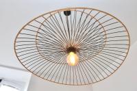 a large wooden fan hanging from a ceiling at Napoléon Gare 5 STUDIO 1er Etage ByLocly in Pontivy