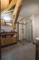 a bathroom with a glass shower and a sink at ODYSSEE A201 Vaste appartement en vieux bois sur les pistes, vue panoramique in La Toussuire