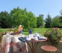 a table with food on it in a garden at Chambres d&#39;Hôtes L’Échappée Belle in Saint-Brisson-sur-Loire