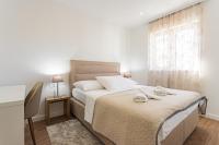 Postel nebo postele na pokoji v ubytování Apartmani Benzon