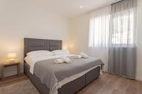 Postel nebo postele na pokoji v ubytování Apartmani Benzon