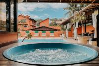 a large blue tub sitting next to a swimming pool at Búzios Centro Hotel in Búzios